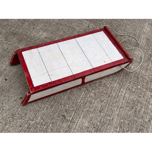 11 - Painted wooden sledge with metal runners.

This lot is available for in-house shipping