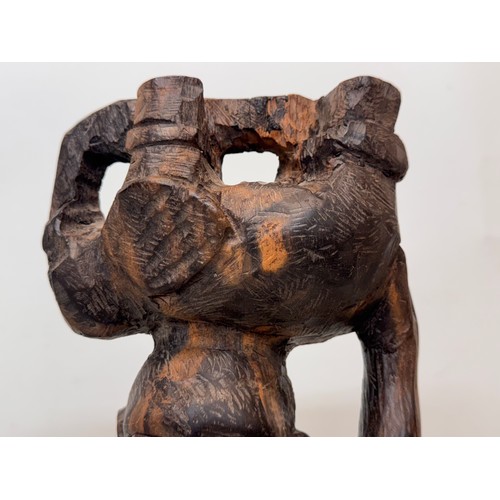 12 - African folk art, hand carved hardwood figure of an elephant  hunter / poacher, 52 cm high.

This lo... 