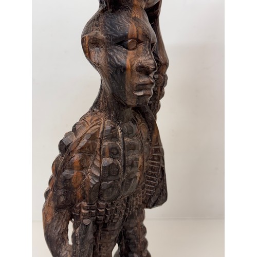 12 - African folk art, hand carved hardwood figure of an elephant  hunter / poacher, 52 cm high.

This lo... 