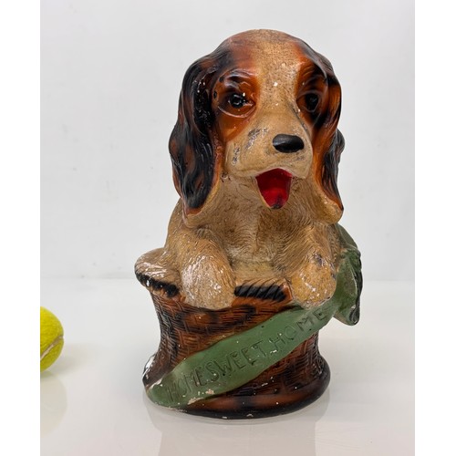 13 - A large painted plaster fairing figure of a puppy in a basket marked home sweet home, C20th kitsch. ... 