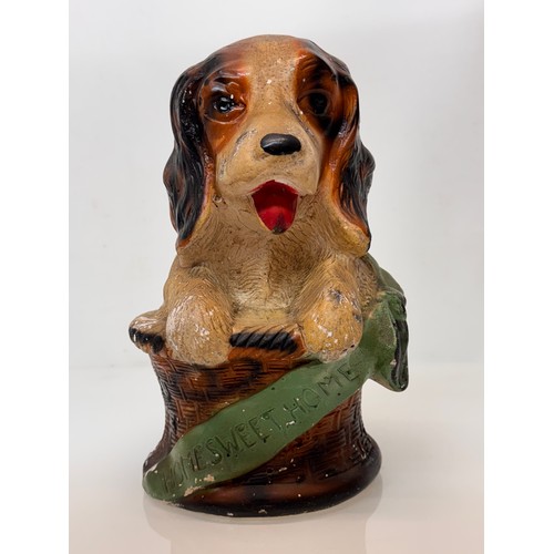 13 - A large painted plaster fairing figure of a puppy in a basket marked home sweet home, C20th kitsch. ... 