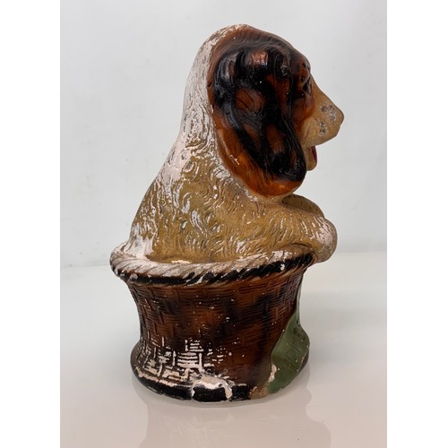 13 - A large painted plaster fairing figure of a puppy in a basket marked home sweet home, C20th kitsch. ... 