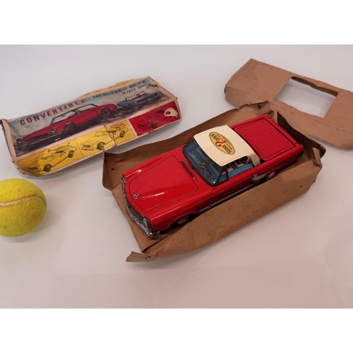 21 - Toys, Tin plate Mercedes SL sports car with retracting roof, mechanism needs attention.

This lot is... 