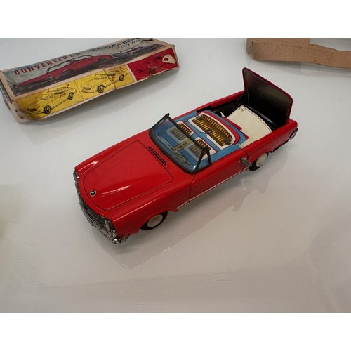 21 - Toys, Tin plate Mercedes SL sports car with retracting roof, mechanism needs attention.

This lot is... 