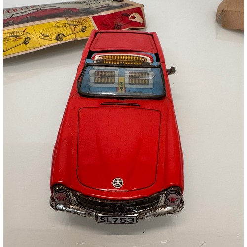 21 - Toys, Tin plate Mercedes SL sports car with retracting roof, mechanism needs attention.

This lot is... 