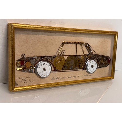 60 - Kitsch automobilia, a framed representation of a Mercedes sports car made from watch parts. 37 cm x ... 