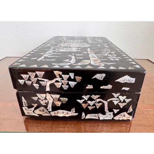 6 - Oriental black laquer box with mother of pearl decoration, 31 cm x18 cm x8 cm tall.

This lot is ava... 