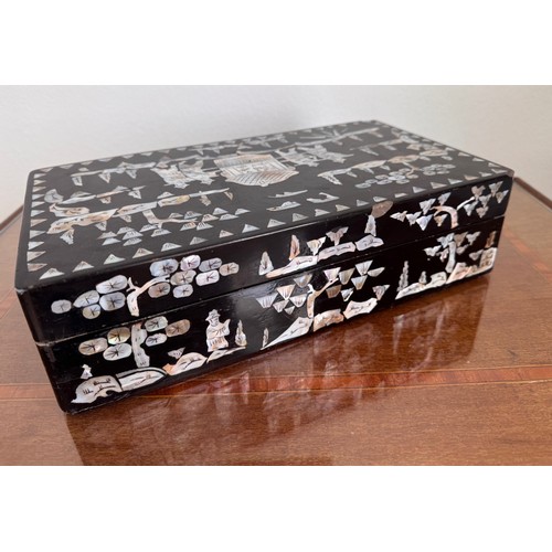 6 - Oriental black laquer box with mother of pearl decoration, 31 cm x18 cm x8 cm tall.

This lot is ava... 