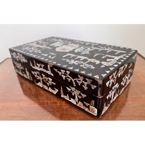 6 - Oriental black laquer box with mother of pearl decoration, 31 cm x18 cm x8 cm tall.

This lot is ava... 