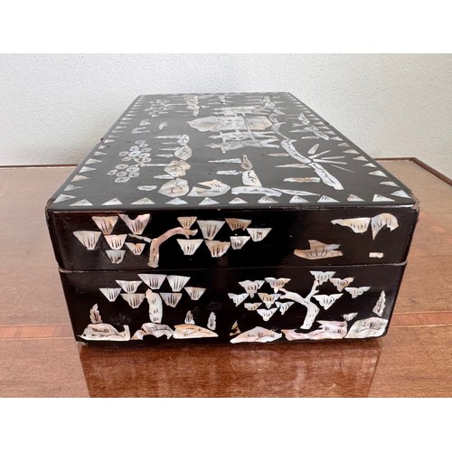 6 - Oriental black laquer box with mother of pearl decoration, 31 cm x18 cm x8 cm tall.

This lot is ava... 