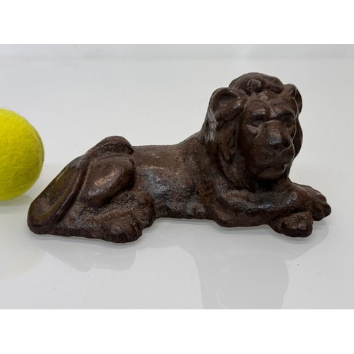 41 - Cast iron figural door stop, a recumbent lion. 21 cm long.

This lot is available for in-house shipp... 