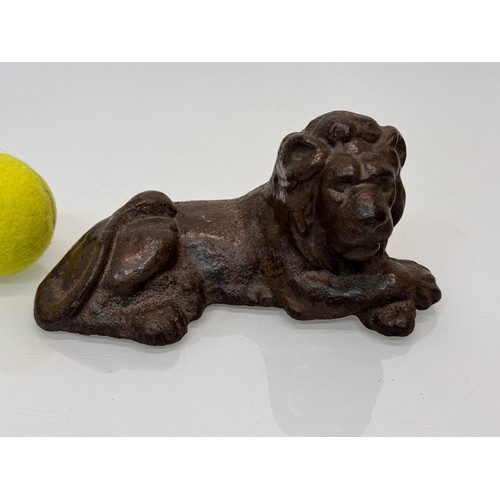 41 - Cast iron figural door stop, a recumbent lion. 21 cm long.

This lot is available for in-house shipp... 