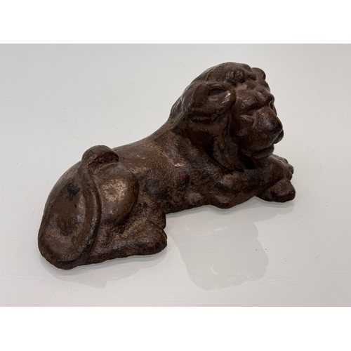 41 - Cast iron figural door stop, a recumbent lion. 21 cm long.

This lot is available for in-house shipp... 