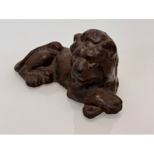 41 - Cast iron figural door stop, a recumbent lion. 21 cm long.

This lot is available for in-house shipp... 