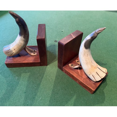 54 - Folk art book ends carved horn in the form of birds, each 18 cm tall.

This lot is available for in-... 