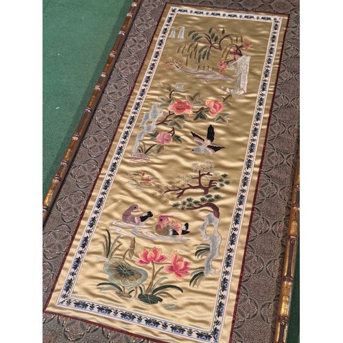 55 - Chinese textiles a framed decorative embroidered silk panel, 62 cm x 30 cm.

This lot is available f... 