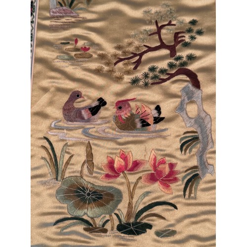 55 - Chinese textiles a framed decorative embroidered silk panel, 62 cm x 30 cm.

This lot is available f... 