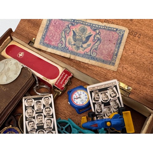 77 - Mixed lot, a Vintage cigar box containing militaria, badges sporting items and a medal etc.

This lo... 