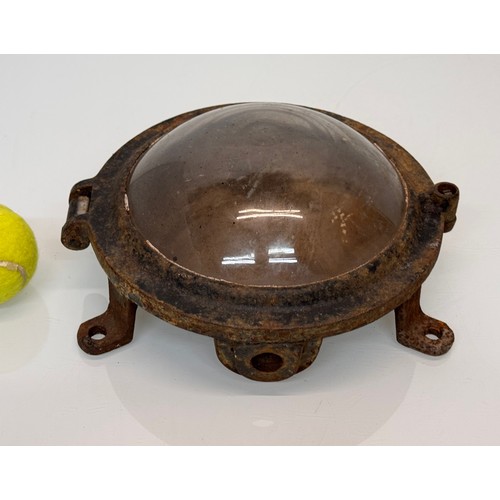 215 - Industrial lighting, a cast iron 9 inch diameter bulkhead light unit.

This lot is available for in-... 