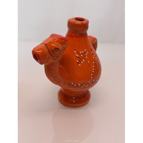 124 - Ceramic jug in the form of a camel with a decorated orange glaze, 18cm tall.

This lot is available ... 