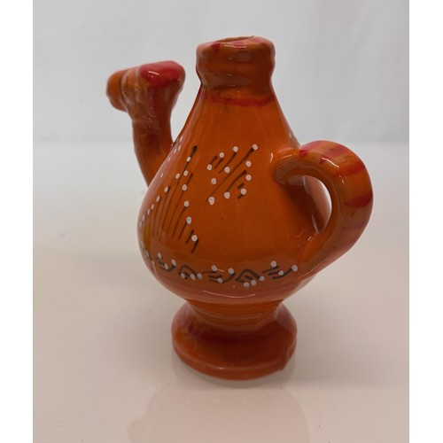 124 - Ceramic jug in the form of a camel with a decorated orange glaze, 18cm tall.

This lot is available ... 