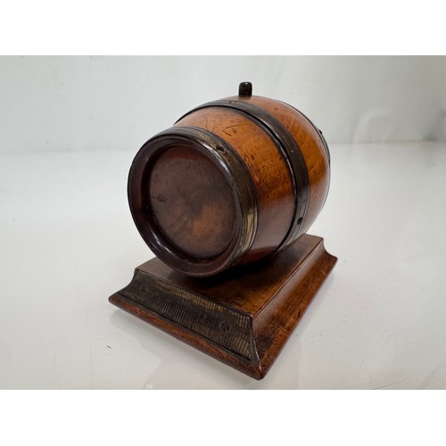 71 - Treen, Match box, in the form of a brass bound barrel on a plinth, sprung end opens for access to th... 