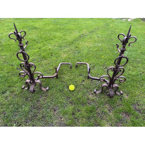 97 - Fire dogs, a pair of large wrought iron fire dogs each 76 cm tall x 52 cm deep and 57 cm wide.

This... 