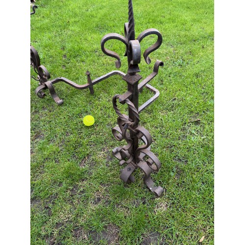97 - Fire dogs, a pair of large wrought iron fire dogs each 76 cm tall x 52 cm deep and 57 cm wide.

This... 