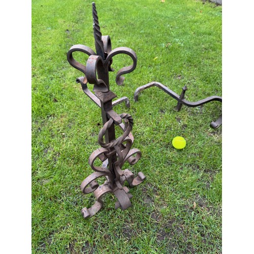97 - Fire dogs, a pair of large wrought iron fire dogs each 76 cm tall x 52 cm deep and 57 cm wide.

This... 