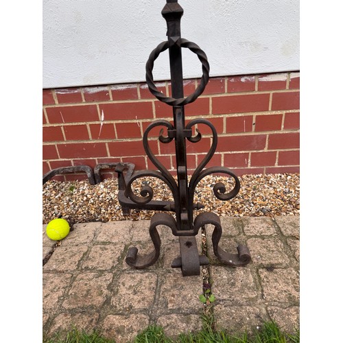 97 - Fire dogs, a pair of large wrought iron fire dogs each 76 cm tall x 52 cm deep and 57 cm wide.

This... 