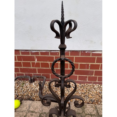97 - Fire dogs, a pair of large wrought iron fire dogs each 76 cm tall x 52 cm deep and 57 cm wide.

This... 