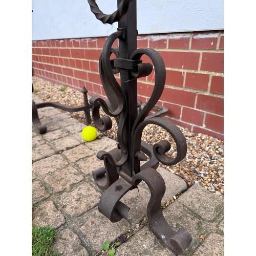 97 - Fire dogs, a pair of large wrought iron fire dogs each 76 cm tall x 52 cm deep and 57 cm wide.

This... 