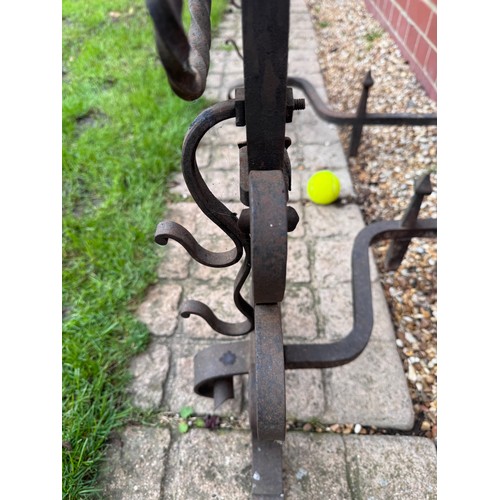97 - Fire dogs, a pair of large wrought iron fire dogs each 76 cm tall x 52 cm deep and 57 cm wide.

This... 
