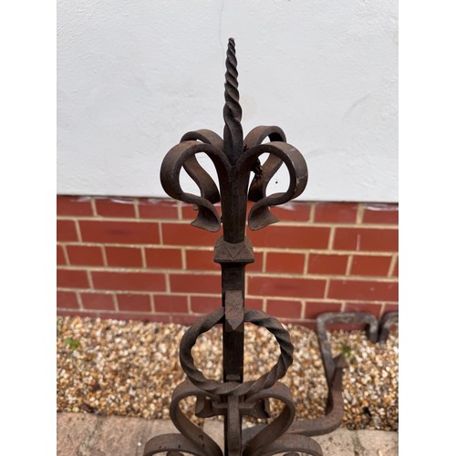 97 - Fire dogs, a pair of large wrought iron fire dogs each 76 cm tall x 52 cm deep and 57 cm wide.

This... 