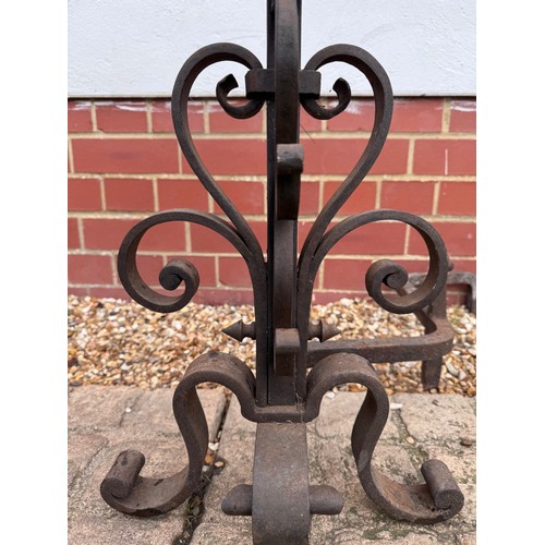 97 - Fire dogs, a pair of large wrought iron fire dogs each 76 cm tall x 52 cm deep and 57 cm wide.

This... 