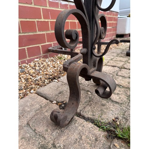 97 - Fire dogs, a pair of large wrought iron fire dogs each 76 cm tall x 52 cm deep and 57 cm wide.

This... 