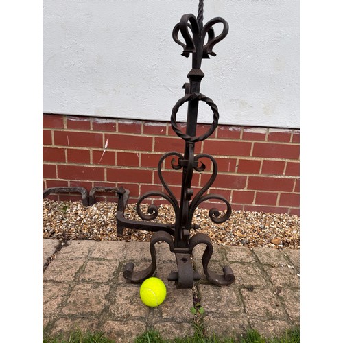 97 - Fire dogs, a pair of large wrought iron fire dogs each 76 cm tall x 52 cm deep and 57 cm wide.

This... 
