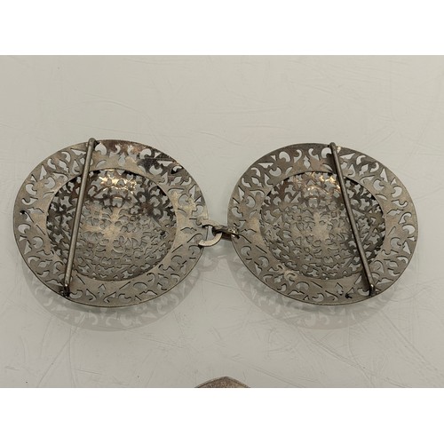 33 - Large white metal belt buckle.

This lot is available for in-house shipping.