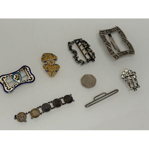 36 - A collection of buckles, silver and enamelled examples and a some linked coins.

This lot is availab... 
