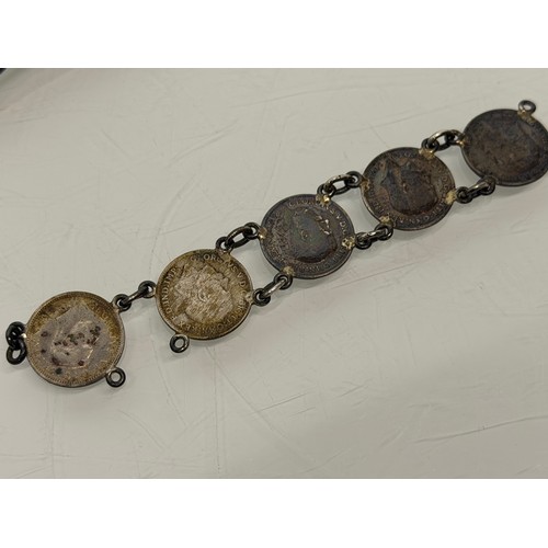 36 - A collection of buckles, silver and enamelled examples and a some linked coins.

This lot is availab... 