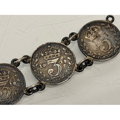 36 - A collection of buckles, silver and enamelled examples and a some linked coins.

This lot is availab... 