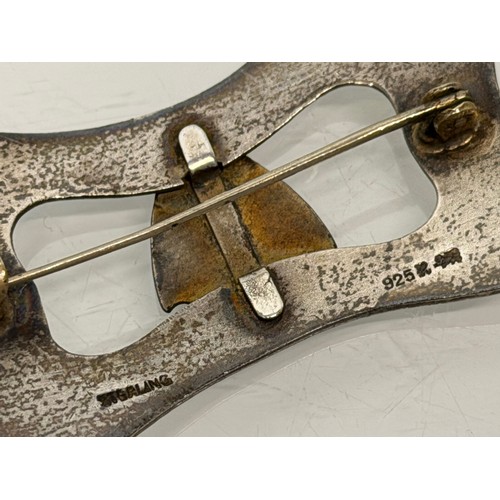 36 - A collection of buckles, silver and enamelled examples and a some linked coins.

This lot is availab... 