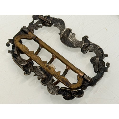 36 - A collection of buckles, silver and enamelled examples and a some linked coins.

This lot is availab... 