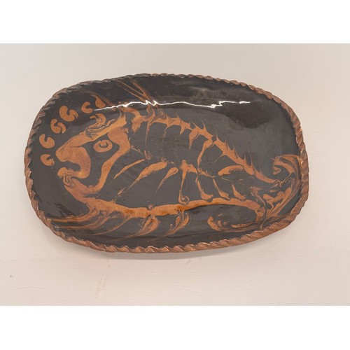38 - English slip ware dish, illustrated with a fish, 29 cm wide.

This lot is available for in-house shi... 