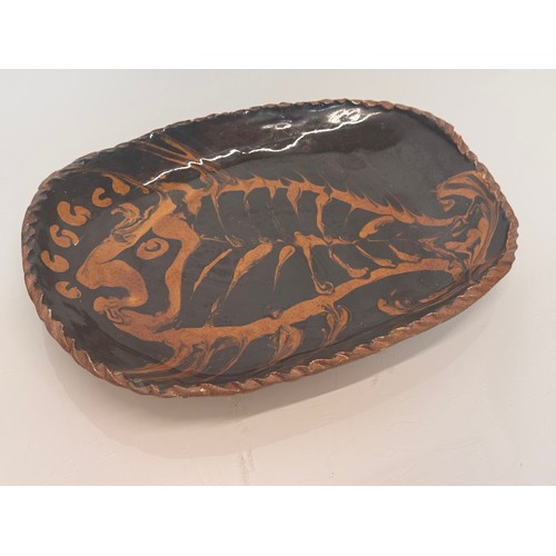 38 - English slip ware dish, illustrated with a fish, 29 cm wide.

This lot is available for in-house shi... 