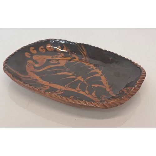 38 - English slip ware dish, illustrated with a fish, 29 cm wide.

This lot is available for in-house shi... 