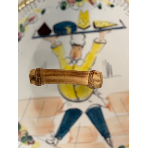 52 - Mid century table wares, a kitch serving platter decorated with an image of a jolly chef, 21 cm in d... 