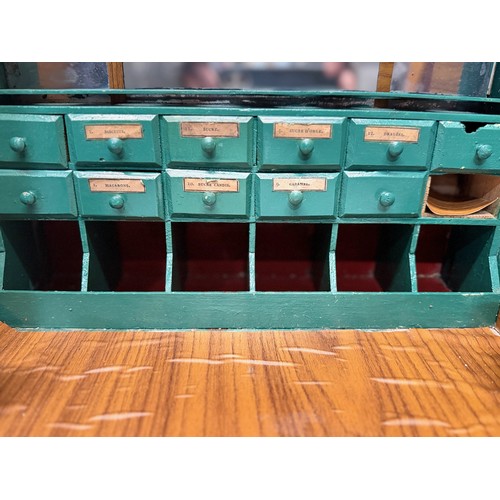 56 - Toys and games, a dolls house type shop counter, 37 cm wide x 41 cm tall x 23 cm deep.

This lot is ... 