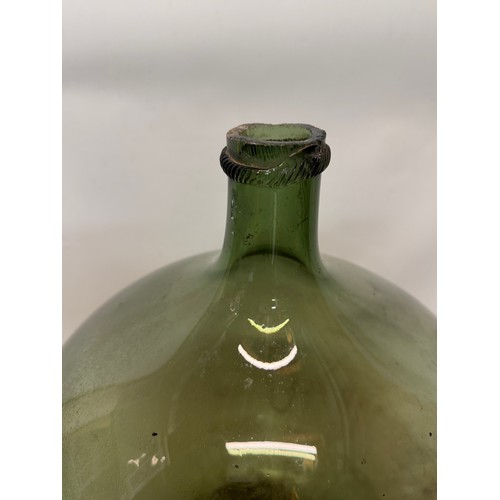 57 - A early C20th century green glass carboy, 35 cm in dia x 40 cm tall.

This lot is collection only