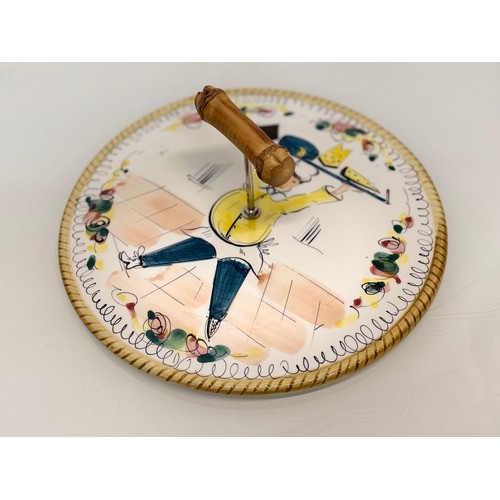 381 - Mid century table wares, a kitch serving platter decorated with an image of a jolly chef, 21 cm in d... 